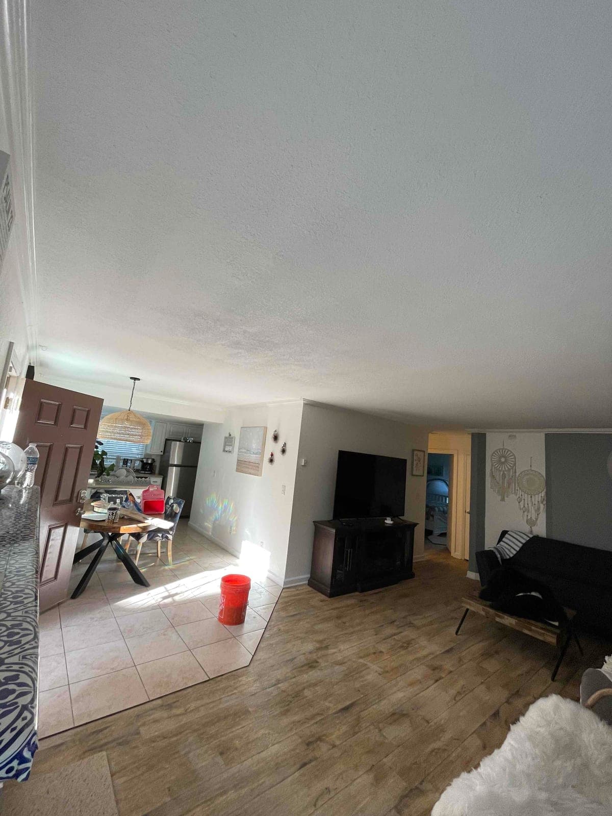 After photo of the repaired living room ceiling with texture blended across the surface.