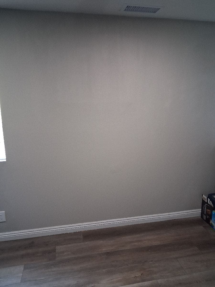 After photo of a finished painted wall after drywall repair work.